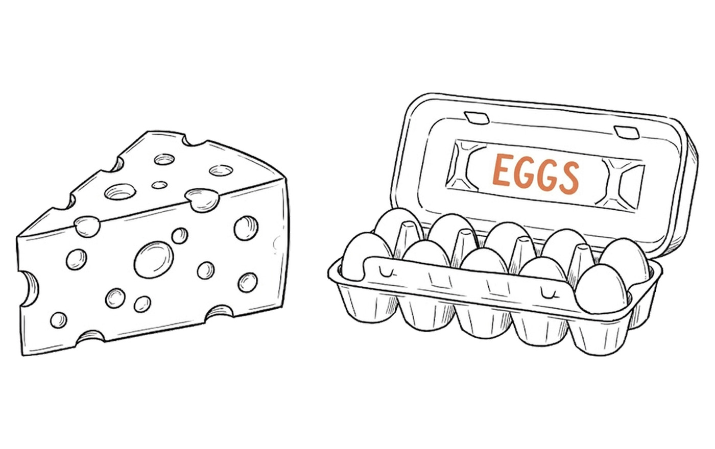 A wedge of cheese and a box of eggs